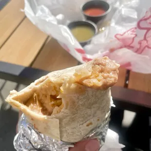 Bean and cheese burrito w/ no rice, red and green salsa in the back