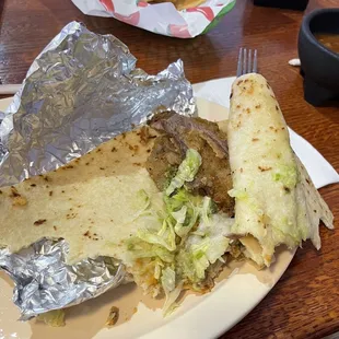 A dry aged milanesa , not crispy , with an old flavor , not enough filling , just cold flour tortilla flavor