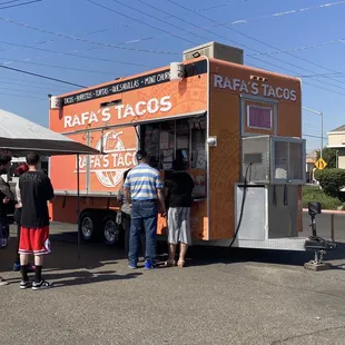people ordering food from a food truck