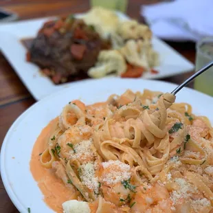 a plate of pasta and meat