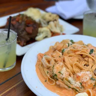a plate of pasta and a drink