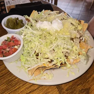 Nachos with jalapenos and salsa on side.