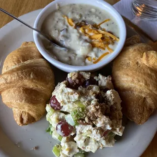 Chicken salad with croissants and potato soup.