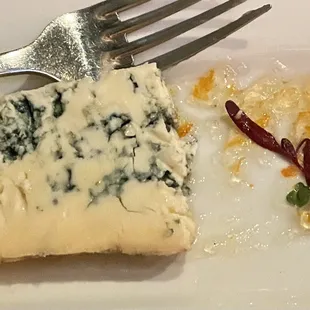 a piece of cheese and a fork