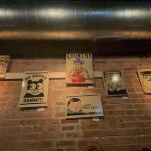 posters on a brick wall