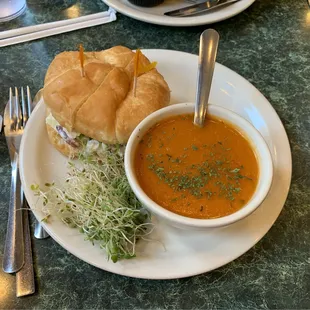 #6 chicken salad sandwich on croissant roll with tomato basil soup.