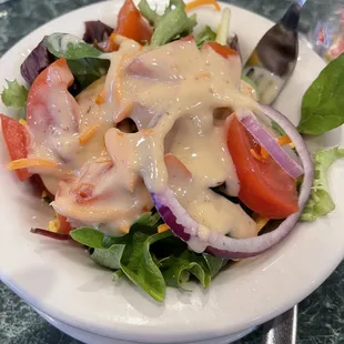 a plate of salad with dressing