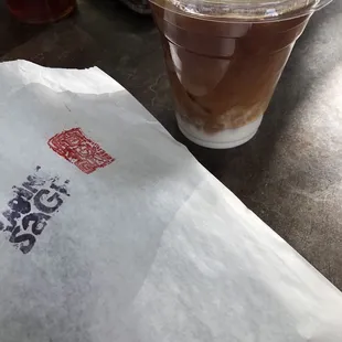 Iced decaf almond milk latte and baked good