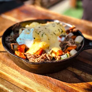 a pot of food on a wooden table