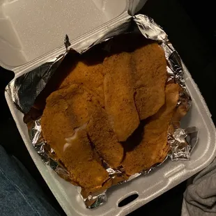 a chicken breast in a styrofoam container