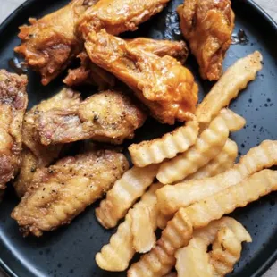 Hot buffalo wings and lemon pepper wings with fries