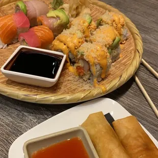 Rainbow roll on the left &amp; supernova roll on the right with two spring rolls