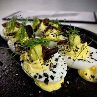 deviled eggs on a black plate