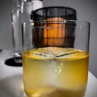 a drink in a glass with ice