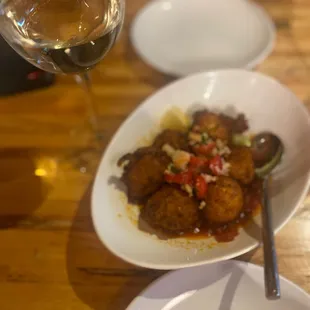 a plate of food and a glass of wine