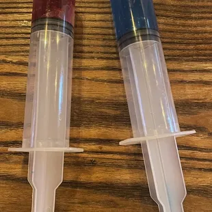 a pair of plastic tubes on a wooden table