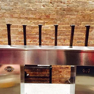 a row of beer taps