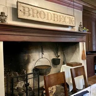 a fireplace with a sign above it