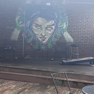a woman&apos;s face painted on the wall