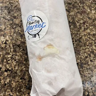 a sandwich wrapped in paper