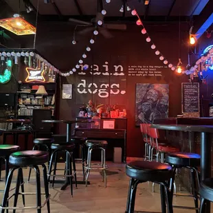 the inside of a bar with stools
