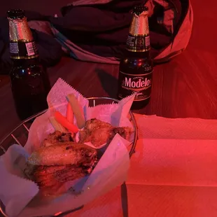 a basket of food and a bottle of beer