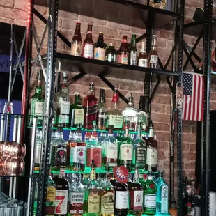 a shelf of liquor bottles