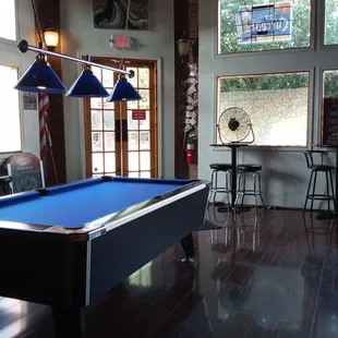 a pool table and a fan