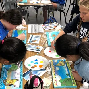 Middle school students focus on painting