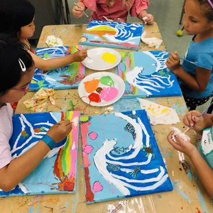 Young artists painting Hokusai 'Great Wave'