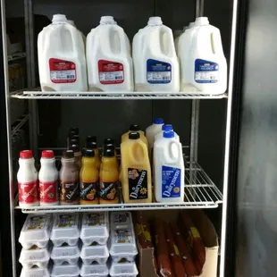 a refrigerator full of milk, eggs, and other foods