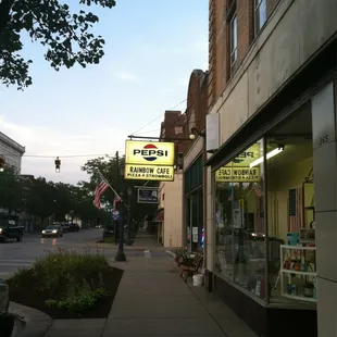 a view of a sidewalk in a small town