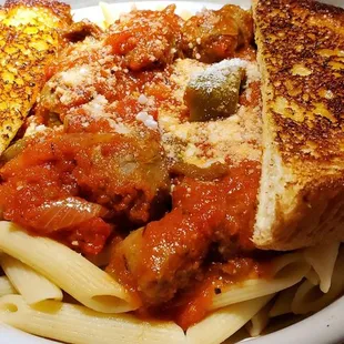 a plate of pasta with meat and cheese