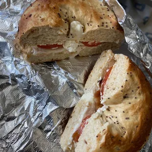 Onion bagel toasted with cream cheese add tomato and bacon.