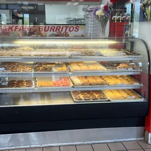 a display case with a variety of donuts