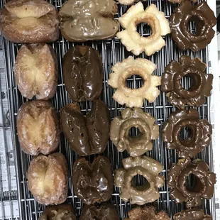 a variety of doughnuts on a cooling rack