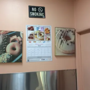 a wall with a calendar and a sign that says no smoking