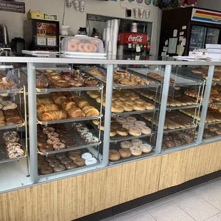 a variety of doughnuts in a display case