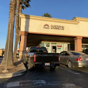 cars parked in front of a donut shop