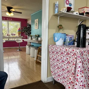Dinning area with large windows and neat chairs, no skipping on lovely décor here..additional seating in back