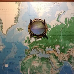 Porthole and world map mural in the front entrance.