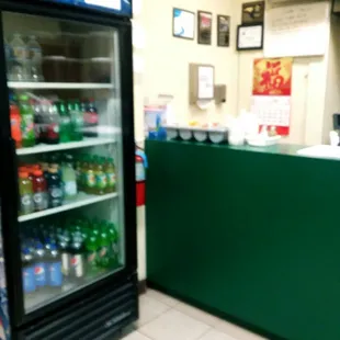 a soda cooler and a counter in a store