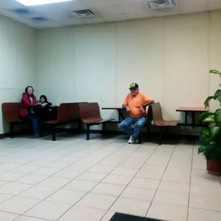 a man and a woman sitting in a waiting room