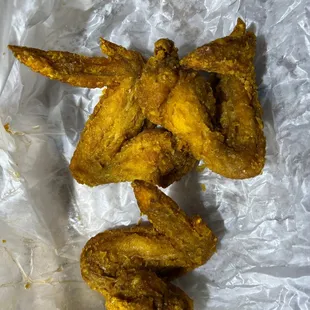fried chicken wings on a piece of tin foil