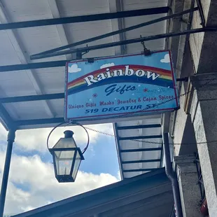 Rainbow Gifts store sign out front.