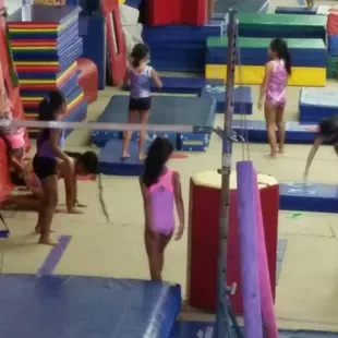 They take turns doing different types of moves,  including front rolls and bridges.