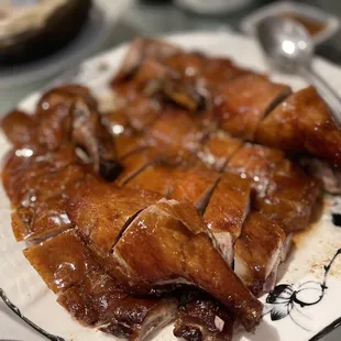 a plate of roast chicken with sauce