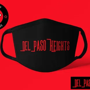 a black face mask with the del paso fights logo on it