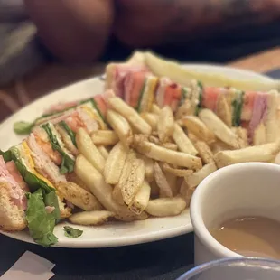 a plate of french fries and a sandwich