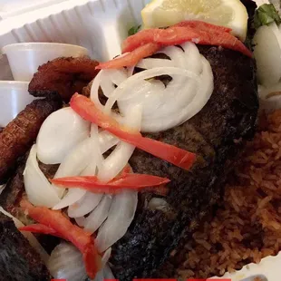 Talapia with jollof rice salad plaintains and stew!